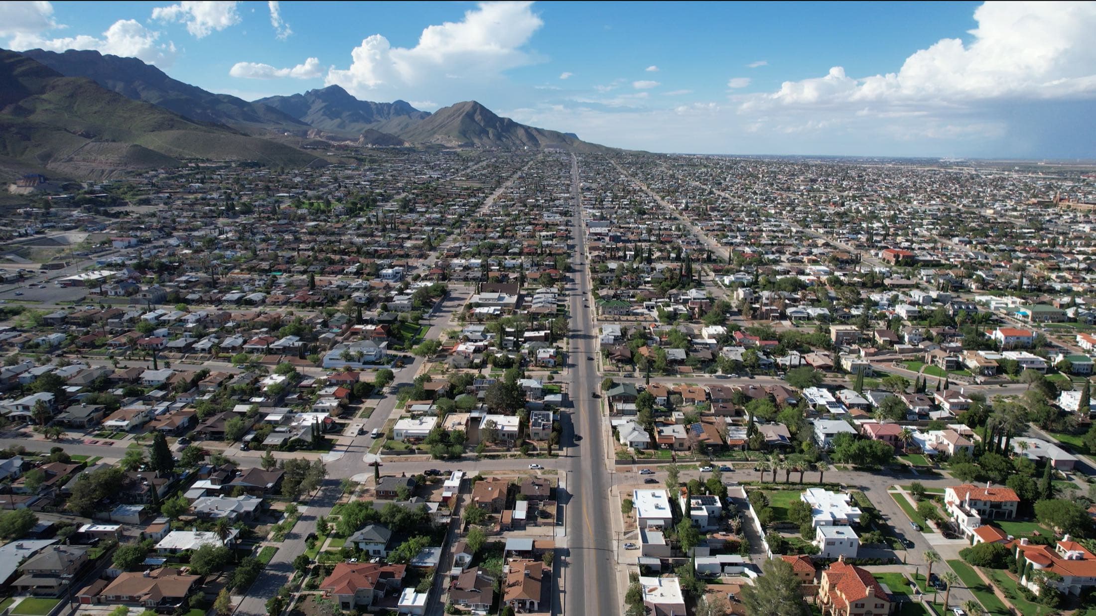 Aerial view of Central El Paso's tree-lined streets running toward the Franklin Mountains