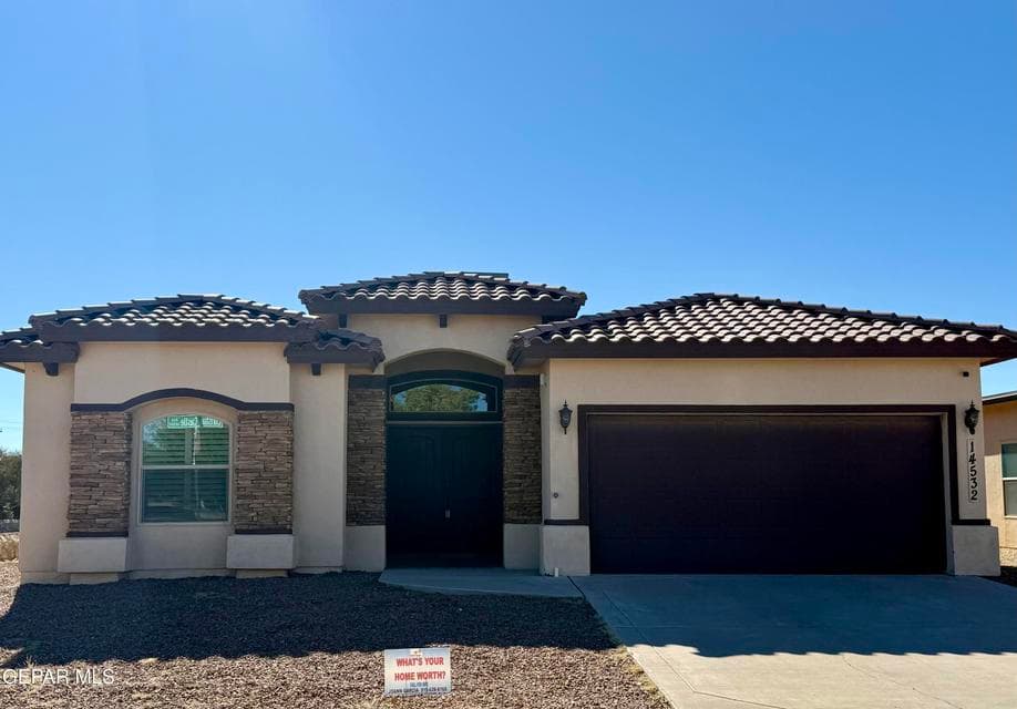 Attractive corner-lot stucco home with stone accents, tile roof, and covered entryway.