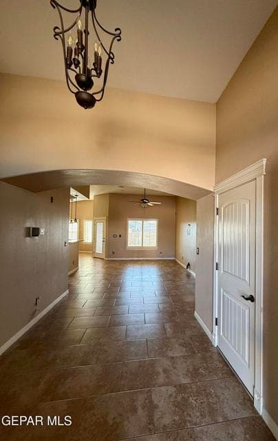 Welcoming entry with arch detail, tile flooring, and direct view into open living areas.