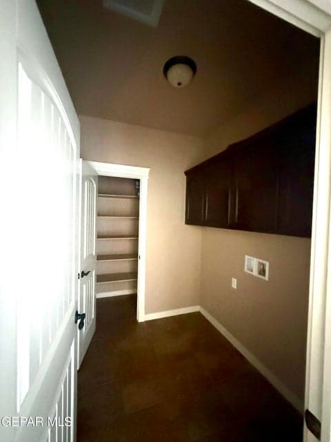 Dedicated laundry room with storage and convenient access to main areas.