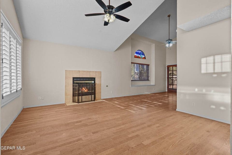 The living room features a cozy fireplace that serves as a focal point. It offers ample space for relaxing or entertaining guests.