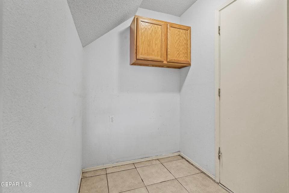 The utility room provides dedicated space for laundry and storage. Its design helps keep daily tasks organized.