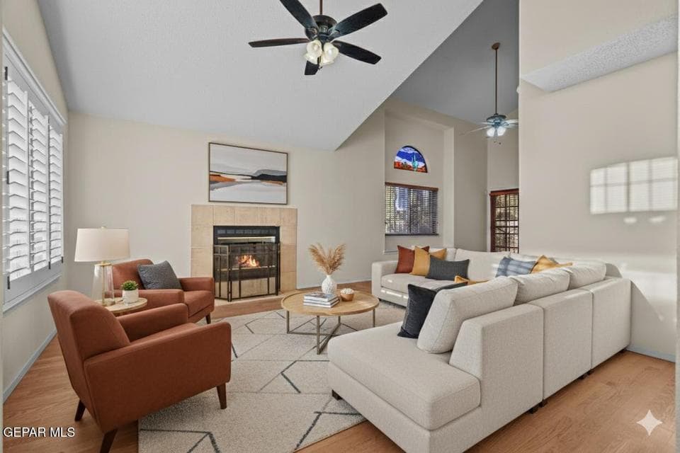The living room features a cozy fireplace that serves as a focal point. It offers ample space for relaxing or entertaining guests.