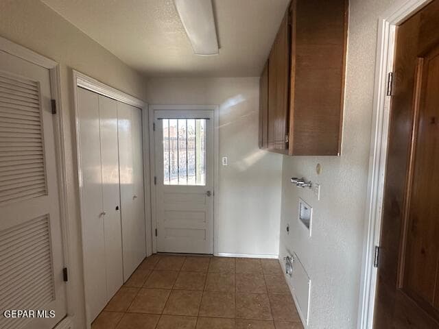 LAUNDRY ROOM WITH LINEN CLOSET AND DOOR TO THE BACKYARD