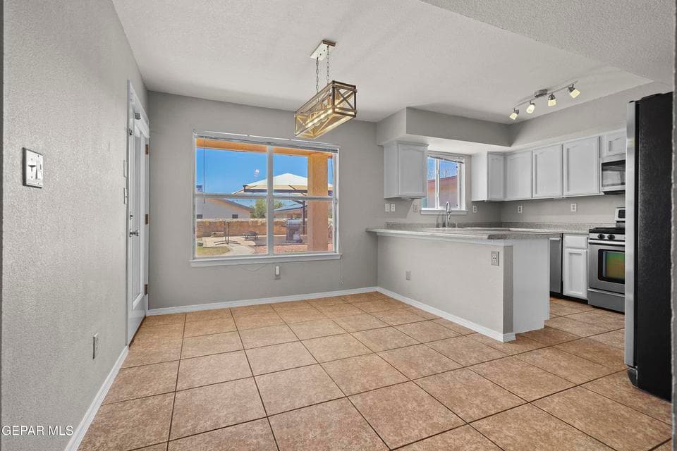 Open dining space, bright natural light, easy kitchen access