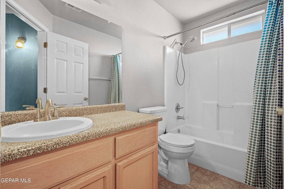 Large vanity with sink, toilet and bathtub