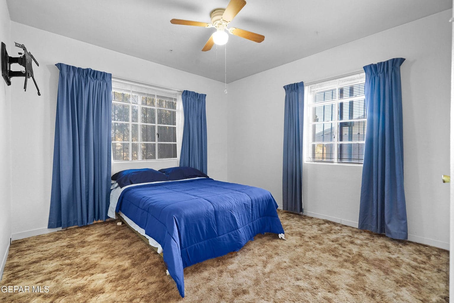 This bedroom offers a comfortable room for a full bedroom setup, creating a restful environment away from the main living areas.
