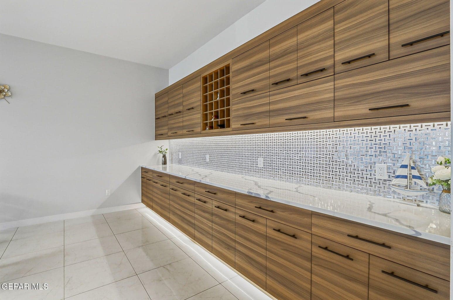 Dining room with butler's pantry, wine rack, quartz counter and glass mosaic back splash