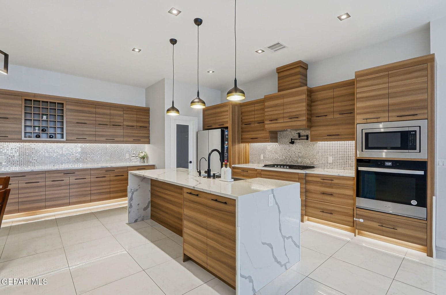 Chef's Kitchen with exhaust, pot filler, counter stove, built in oven and microwave