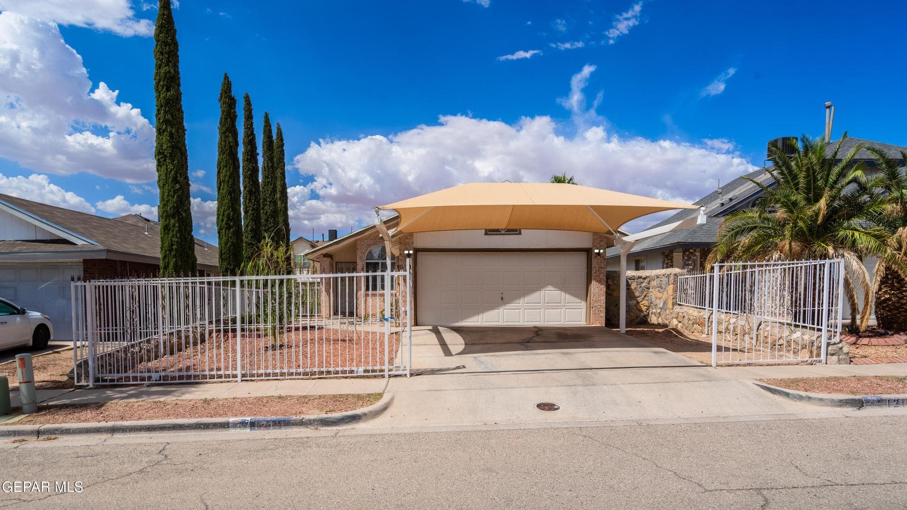 Gated front yard and drive way adds extra privacy and security.