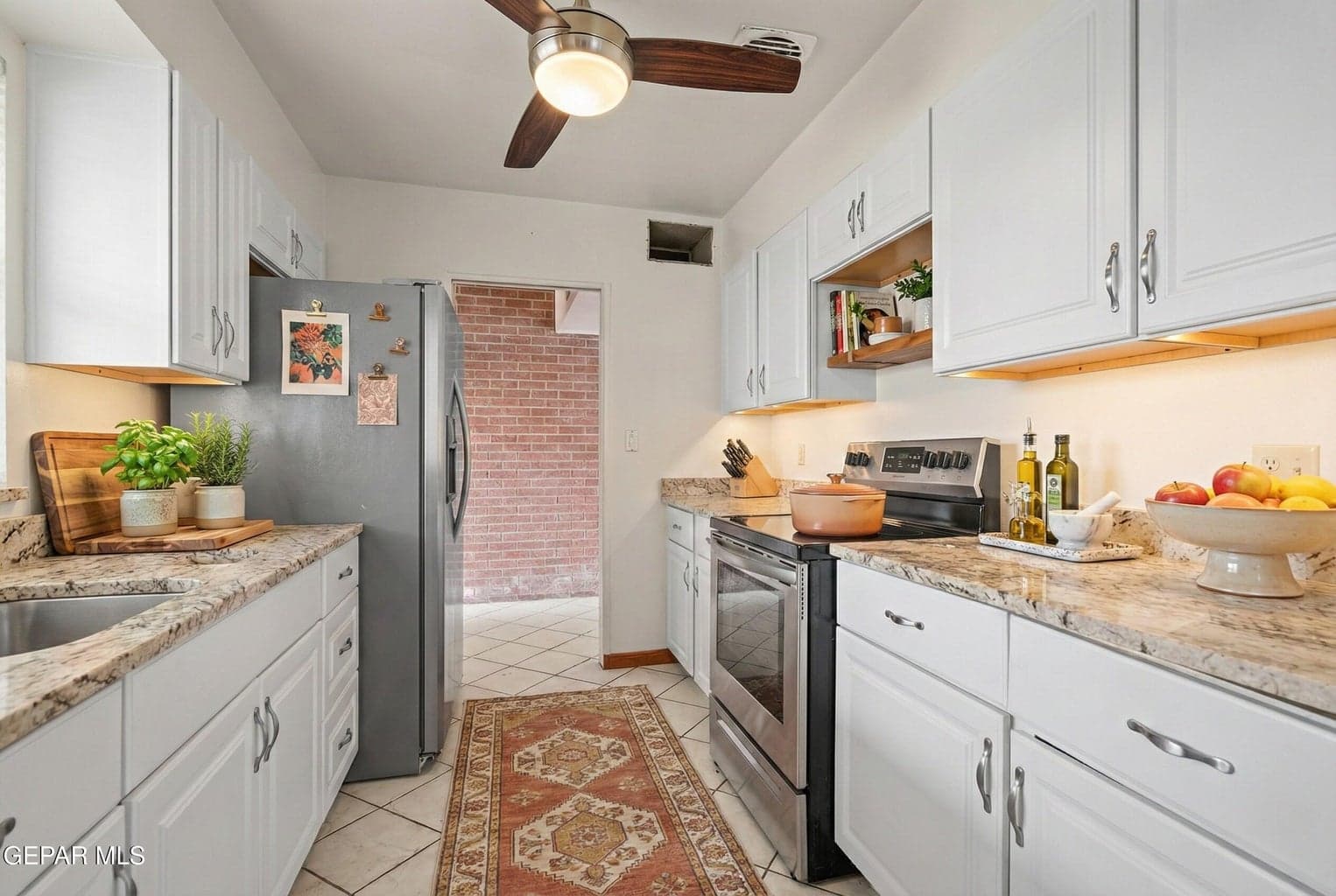 The kitchen is designed for efficiency and everyday use, offering ample cabinetry, generous counter space, and a layout that flows seamlessly into the dining area for easy entertaining.