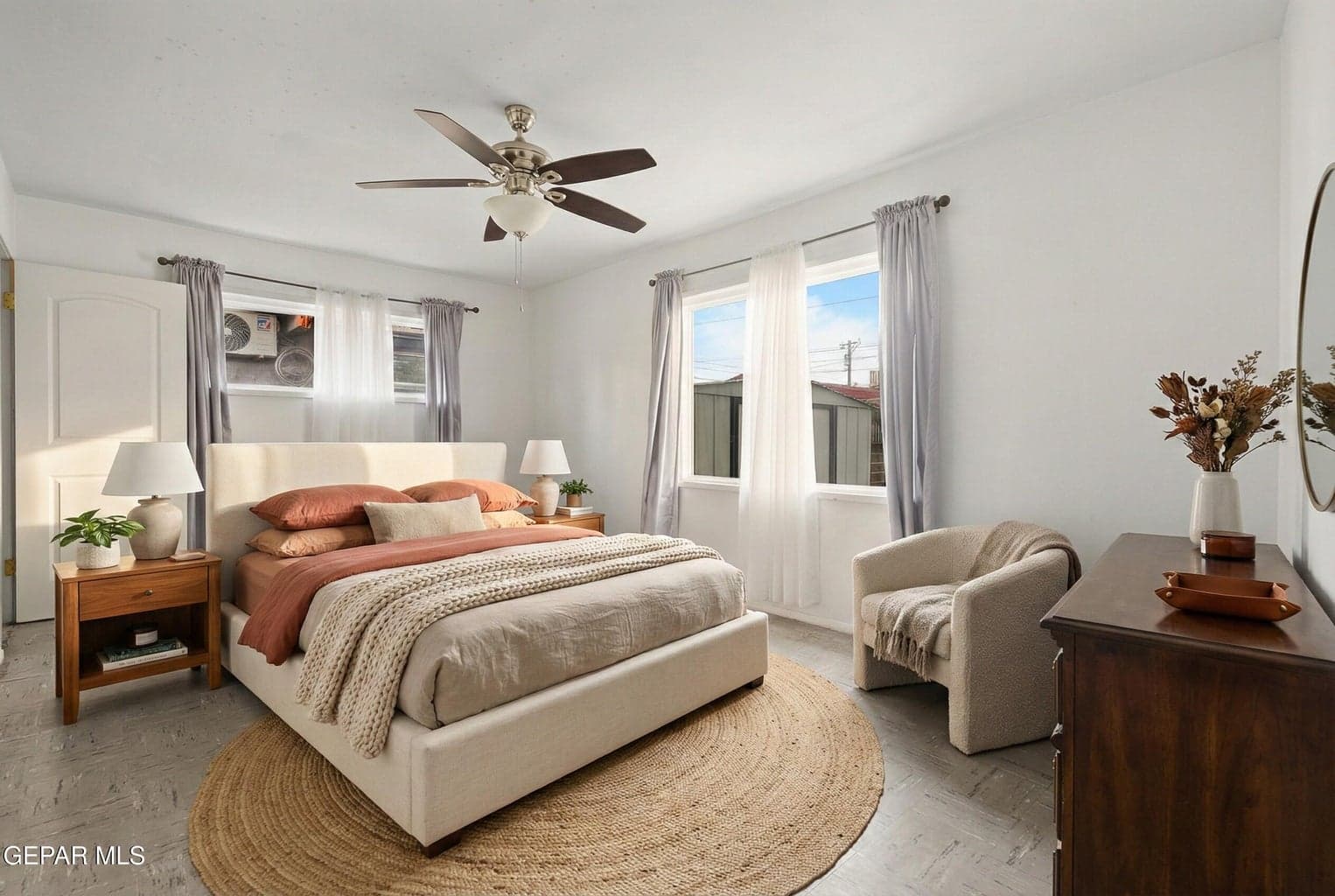 The primary suite offers a private retreat with enough space for a full bedroom setup.