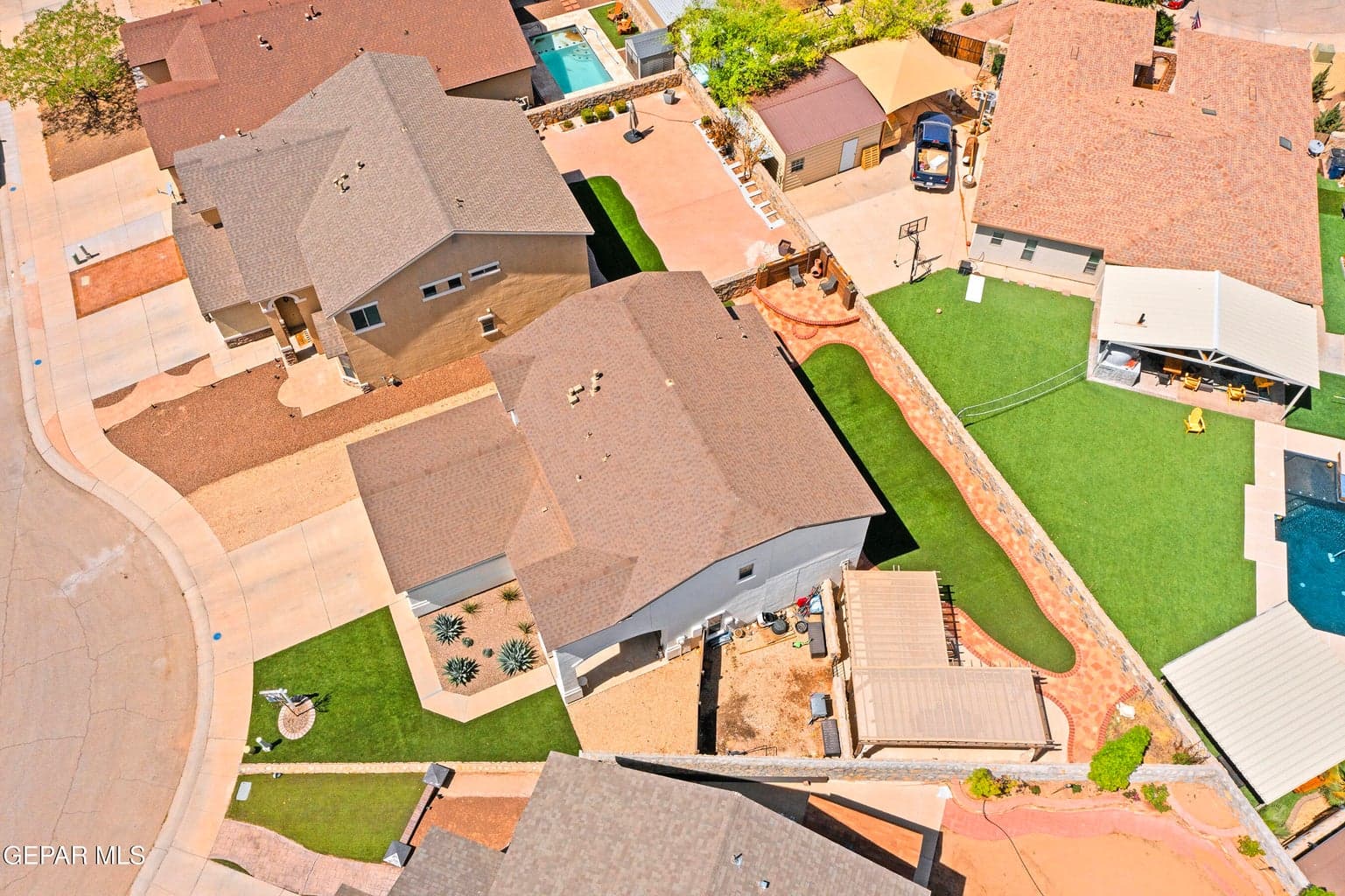 Oversized cul de sac lot with turf, covered pergola, fire pit, sitting areas and more!