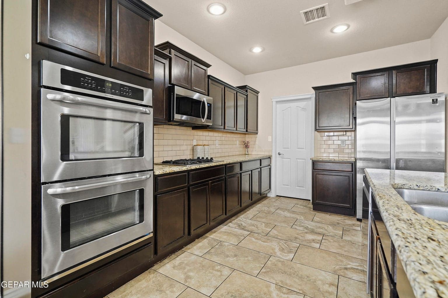 Granite countertops, stainless steel appliances, double ovens