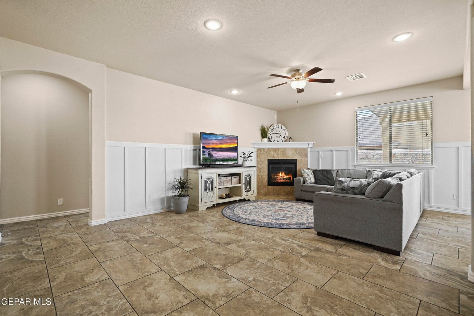 Expansive layout, central gathering space, cozy fireplace. One of many living areas!