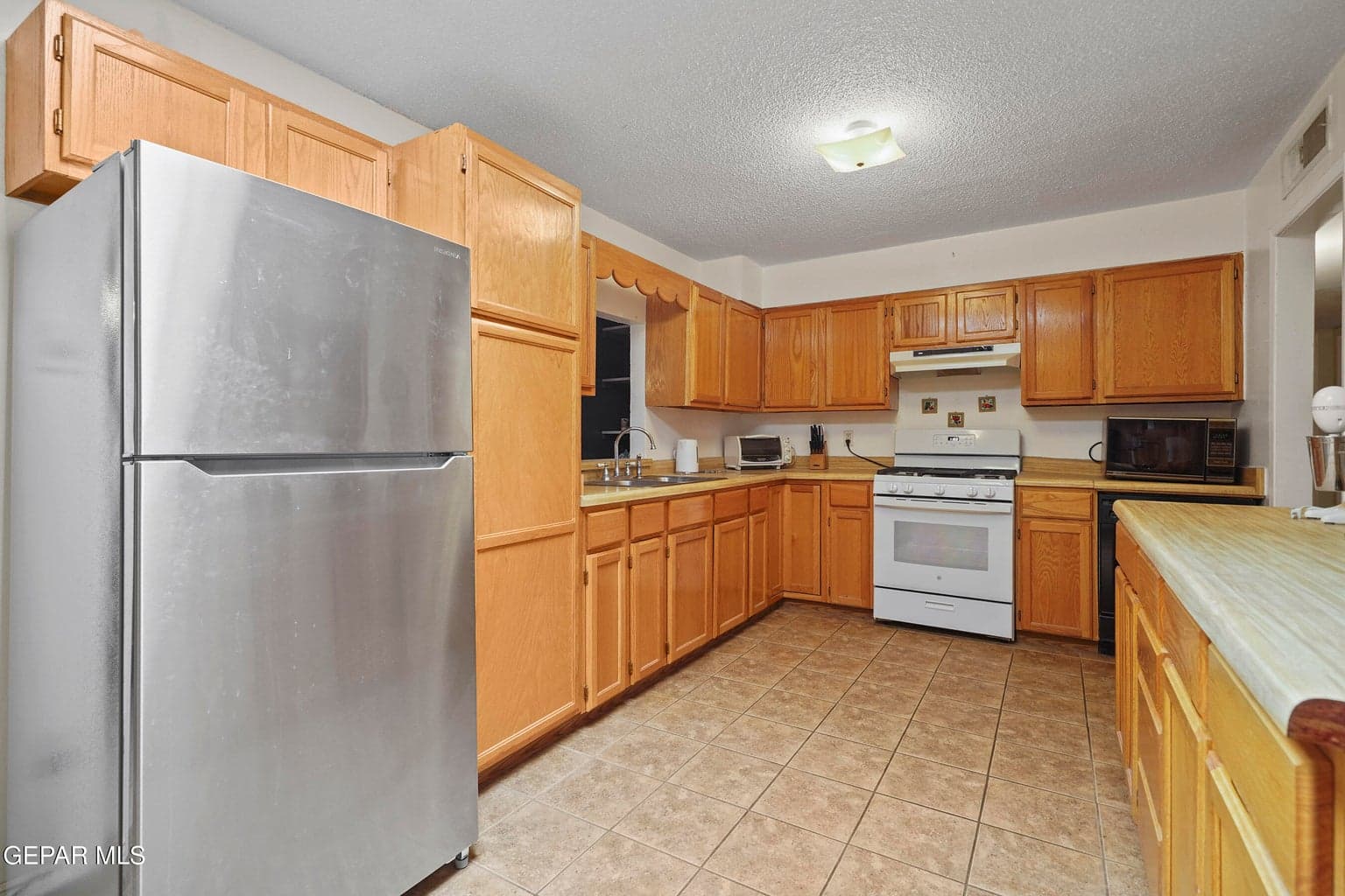 Laminate countertops, abundant cabinet storage