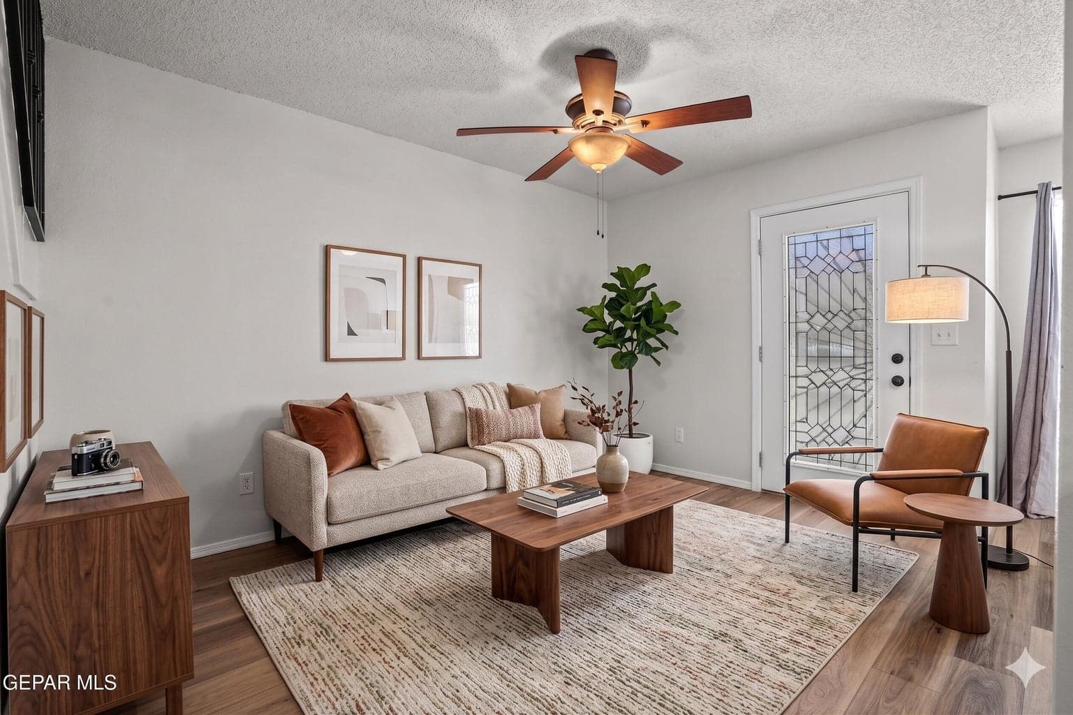 Luxury vinyl plank flooring, ceiling fan comfort, bright gathering space