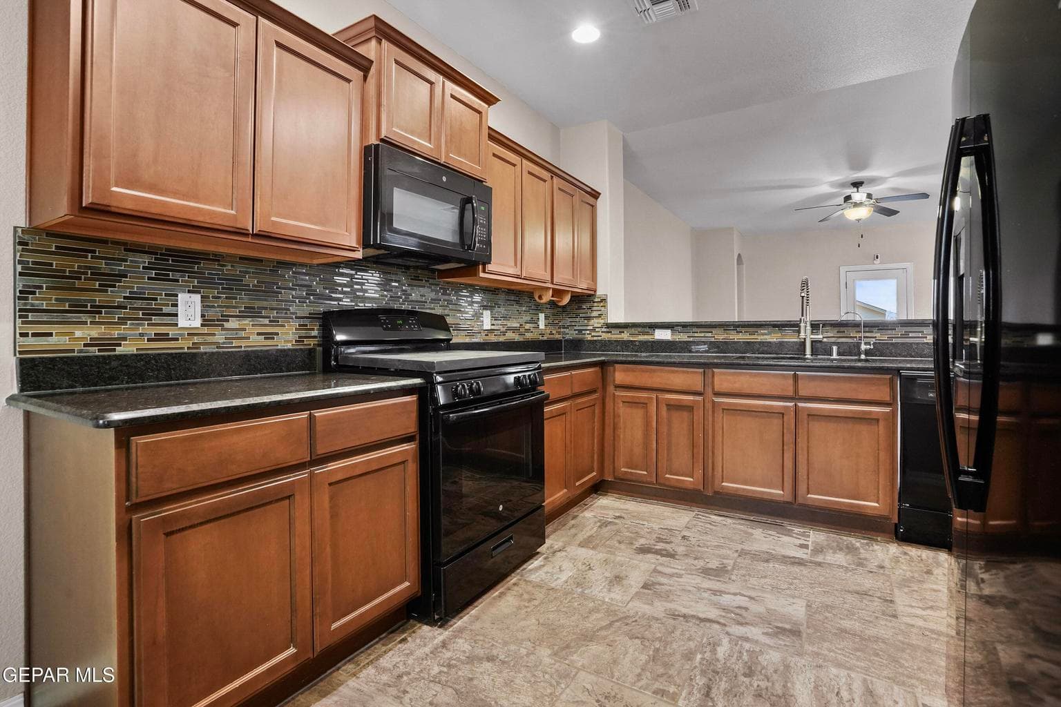 The kitchen features granite countertops, ample cabinetry