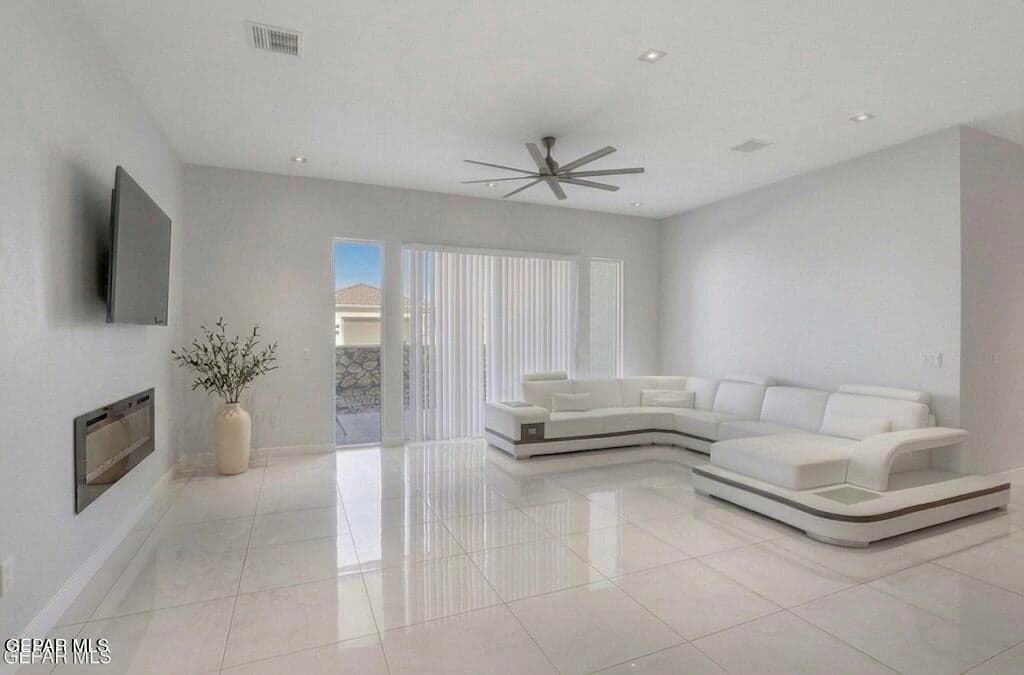 Great room with fireplace to Patio #1 virtually staged