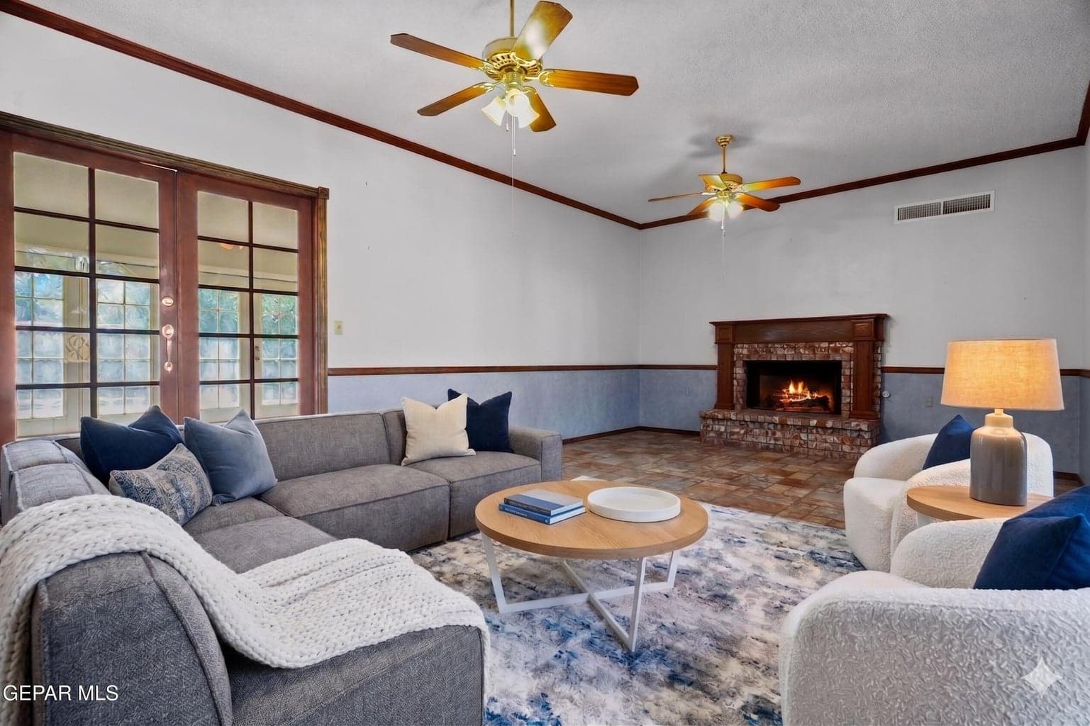 The great room features tile flooring, a cozy fireplace