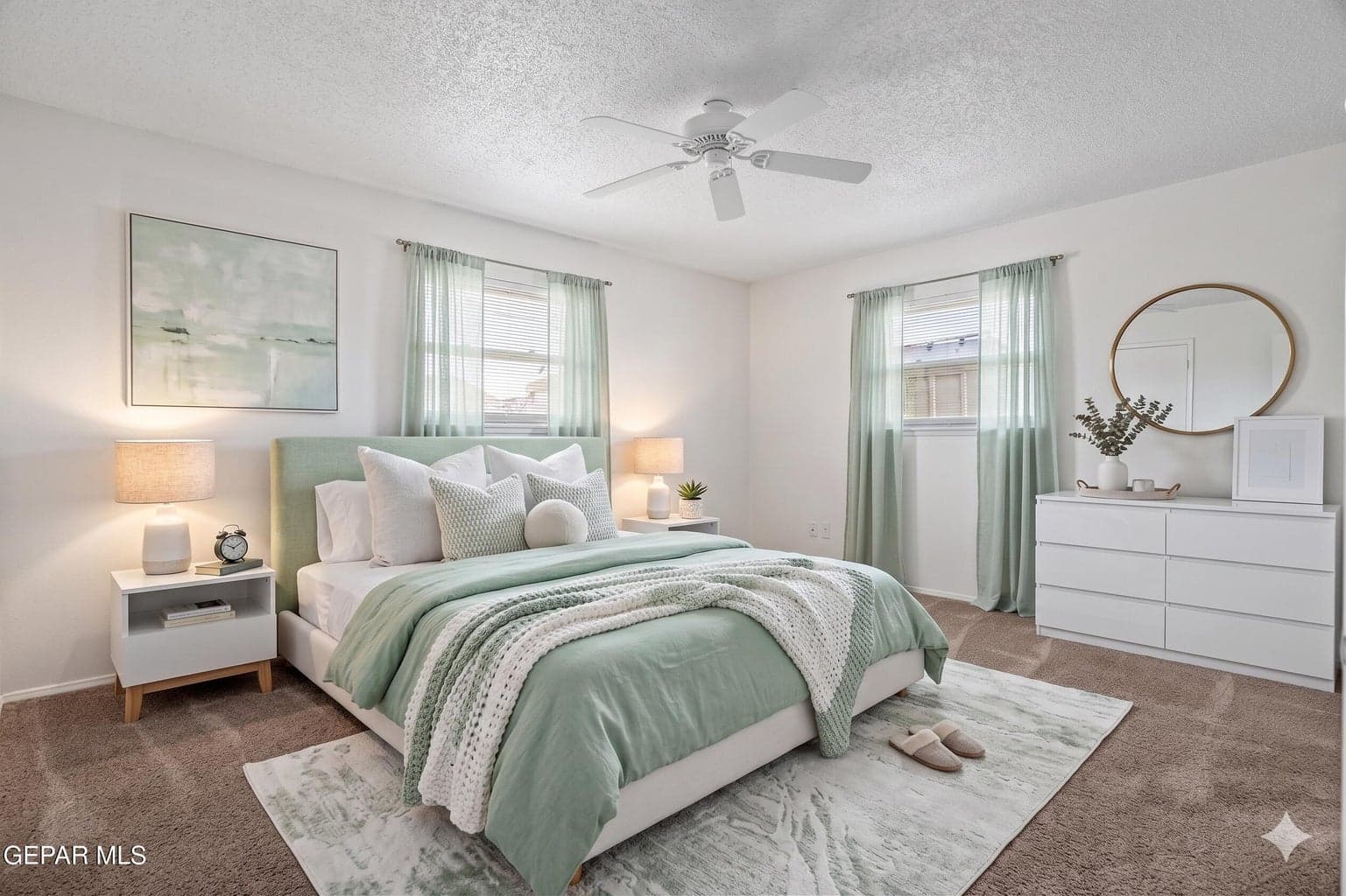 Spacious primary suite features carpet flooring and a built-in closet