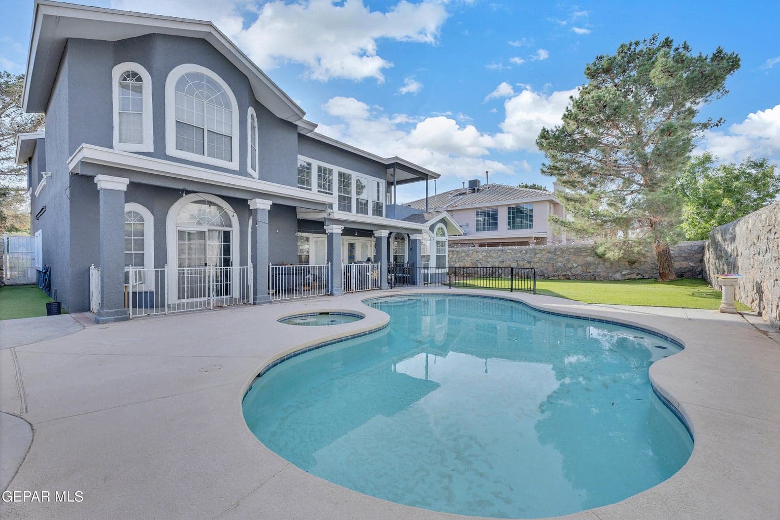 Resort-style backyard with pool and spa.