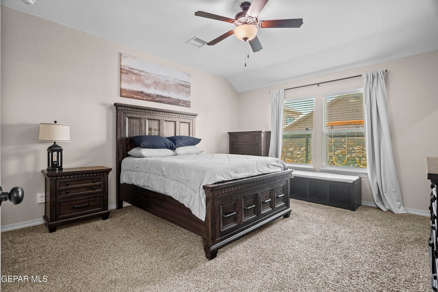 Relax in the spacious primary suite featuring plush carpet flooring
