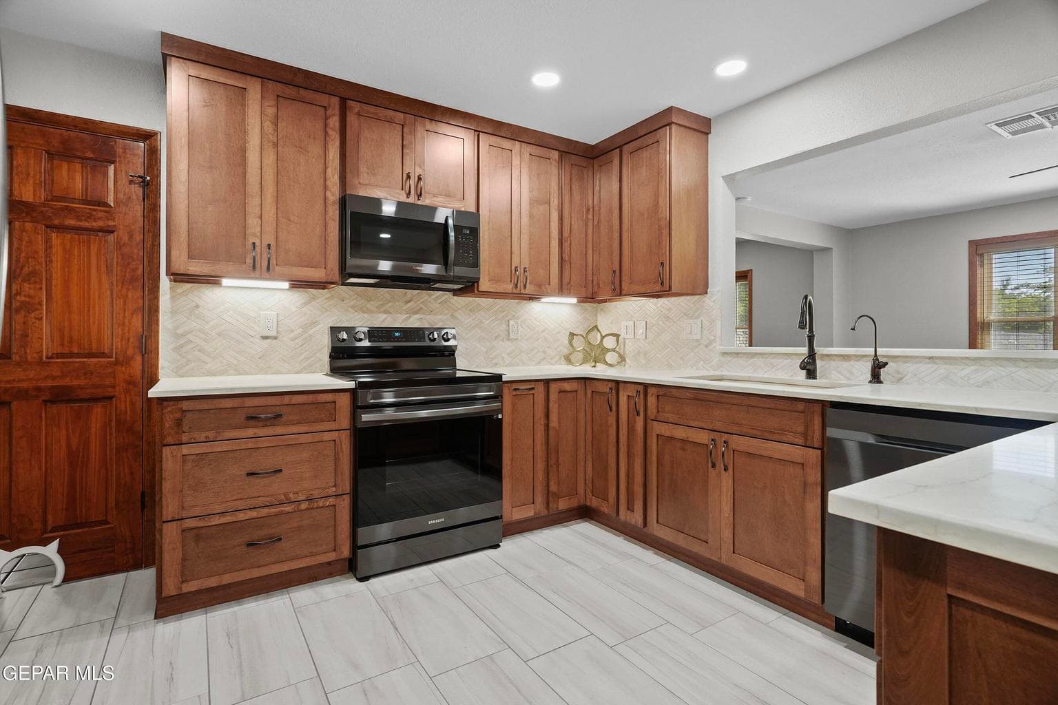 Remodeled with timeless finishes, black stainless steel appliances and quartz countertops.