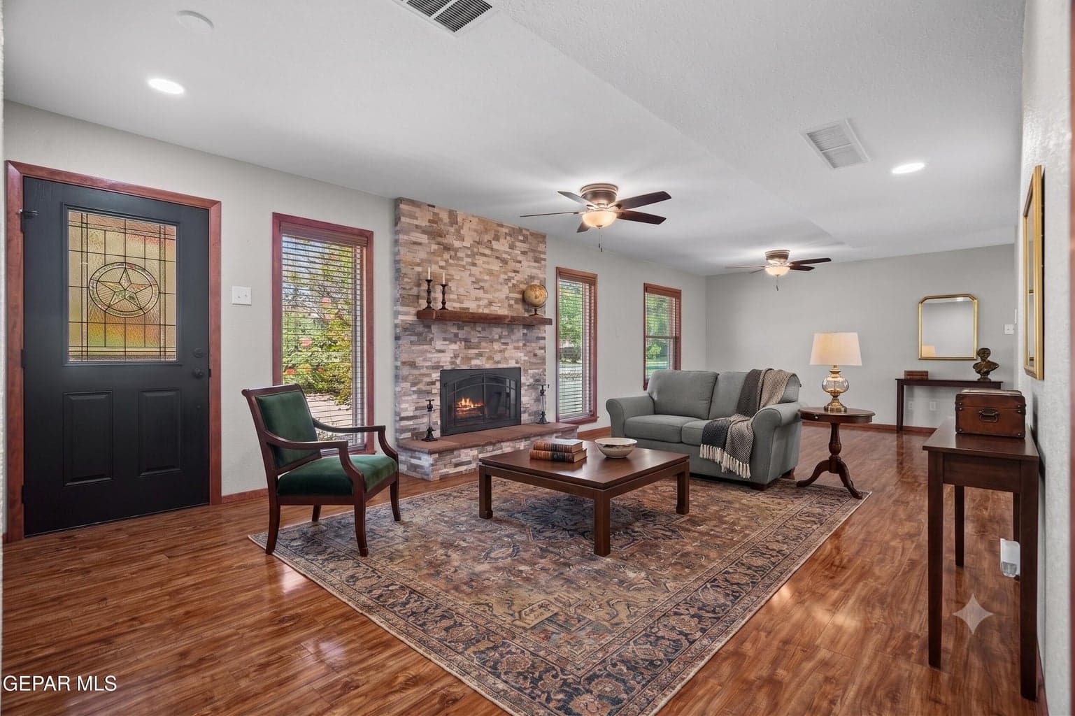 Spacious great room features laminate flooring and a cozy fireplace