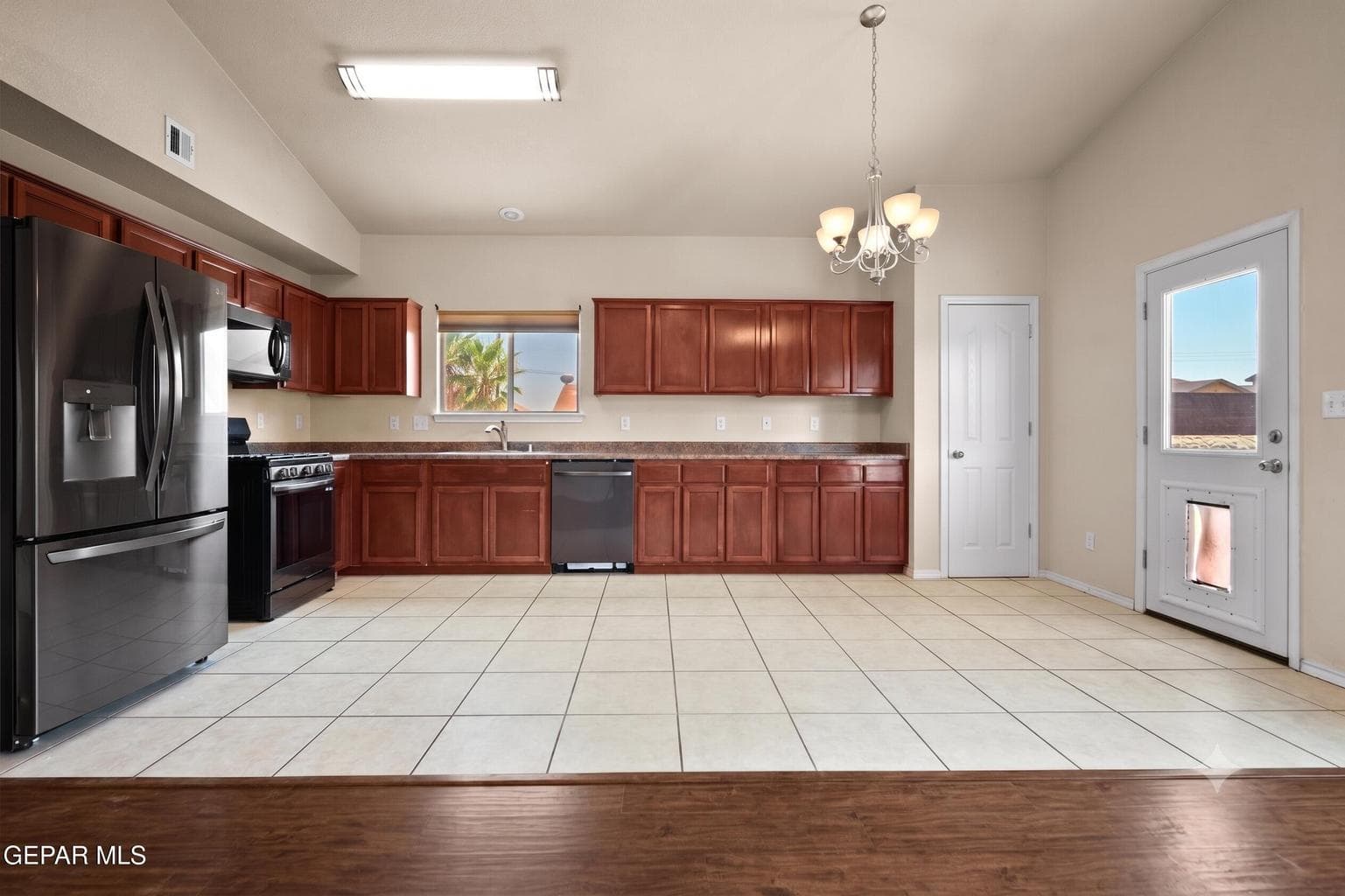 Offers ample cabinetry, and direct access to the backyard.