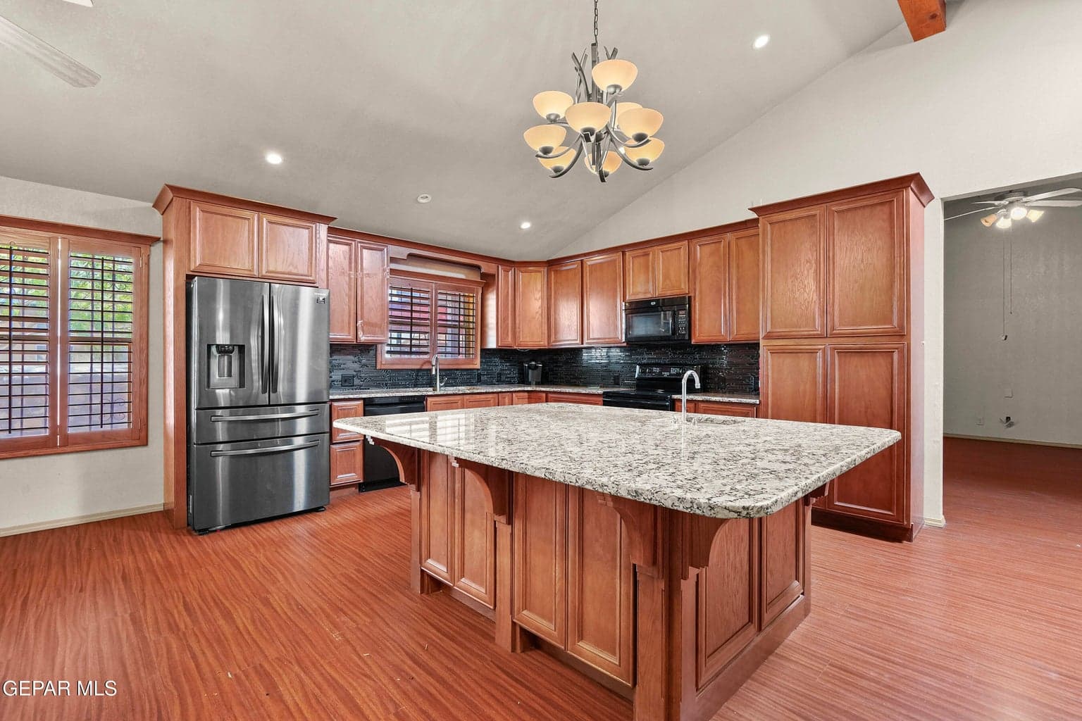 The kitchen features granite countertops, and ample cabinetry