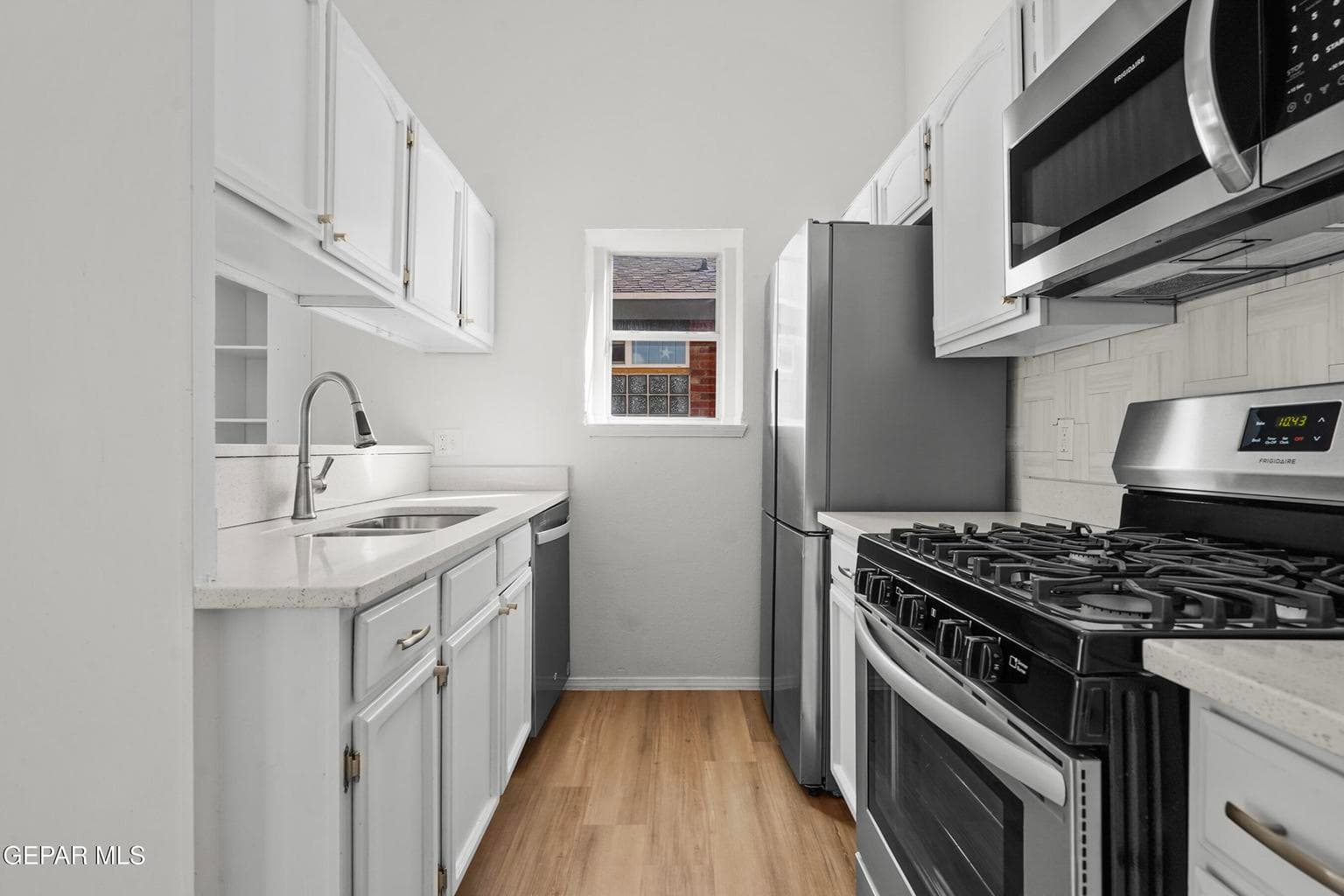 The kitchen is cozy yet functional, featuring beautiful finishes, ample counter space, and modern appliances.