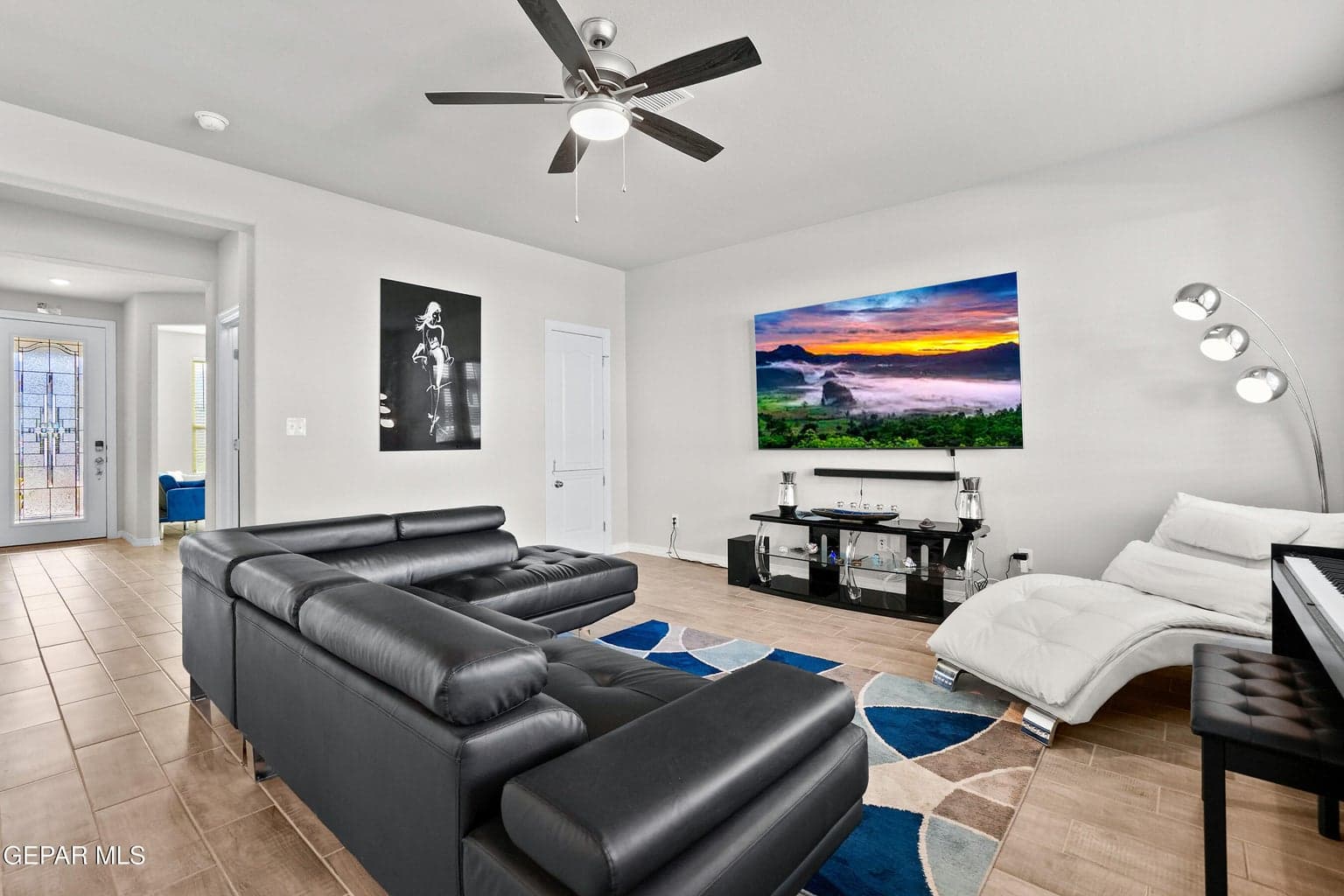 Offers generous space with tile flooring, big windows, and a ceiling fan