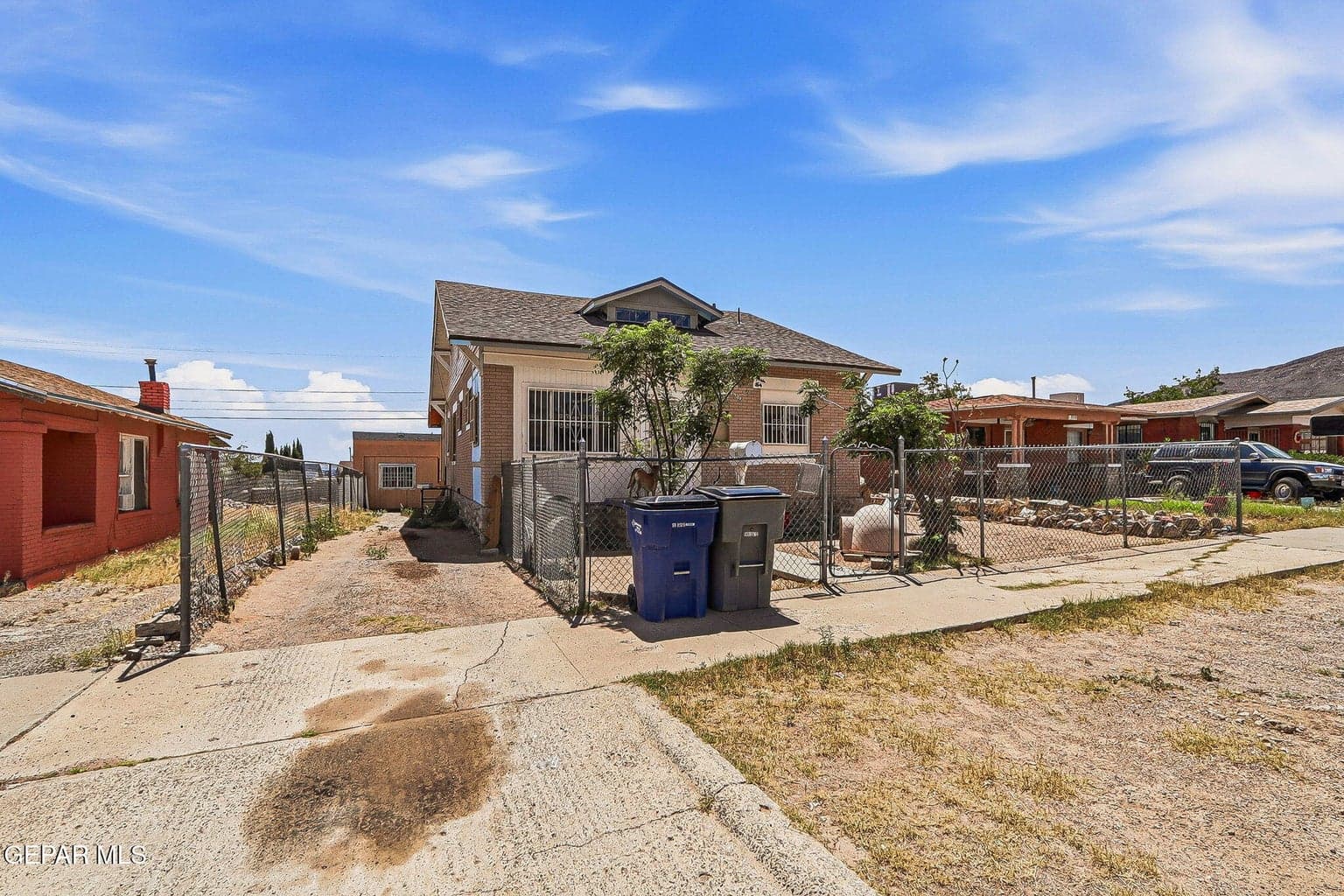 Driveway leading to backyard/garage