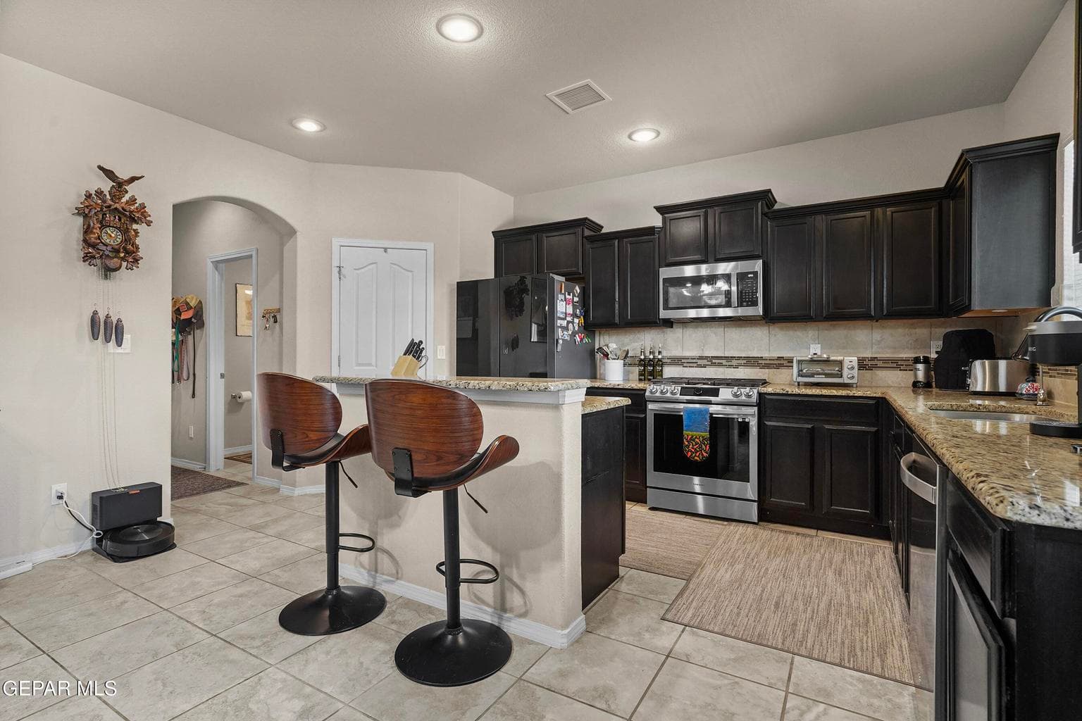 Granite countertops, stainless steel appliances, and ample cabinetry