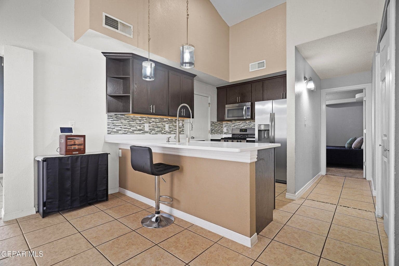 Quartz countertops, ample cabinetry, and stainless steel appliances