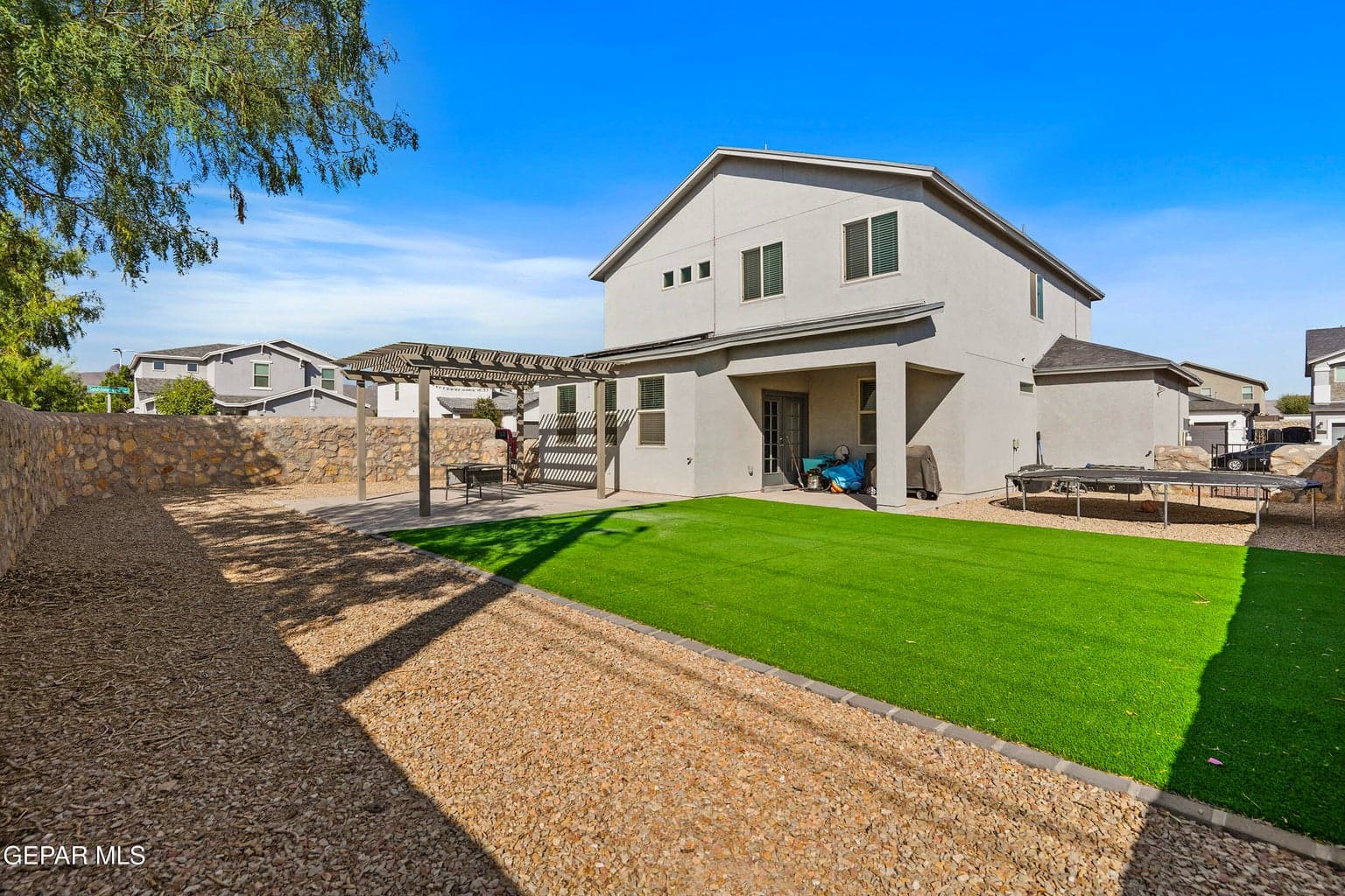You'll love the oversized corner lot with an abundance of room! Elevated rock wall for privacy, turf, and a concrete pad & pergola make this your dream backyard!