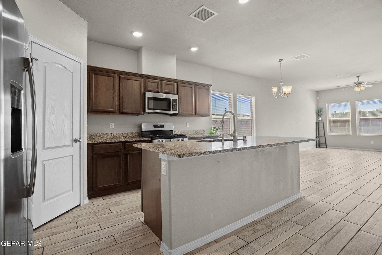 Features granite countertops and ample cabinetry.