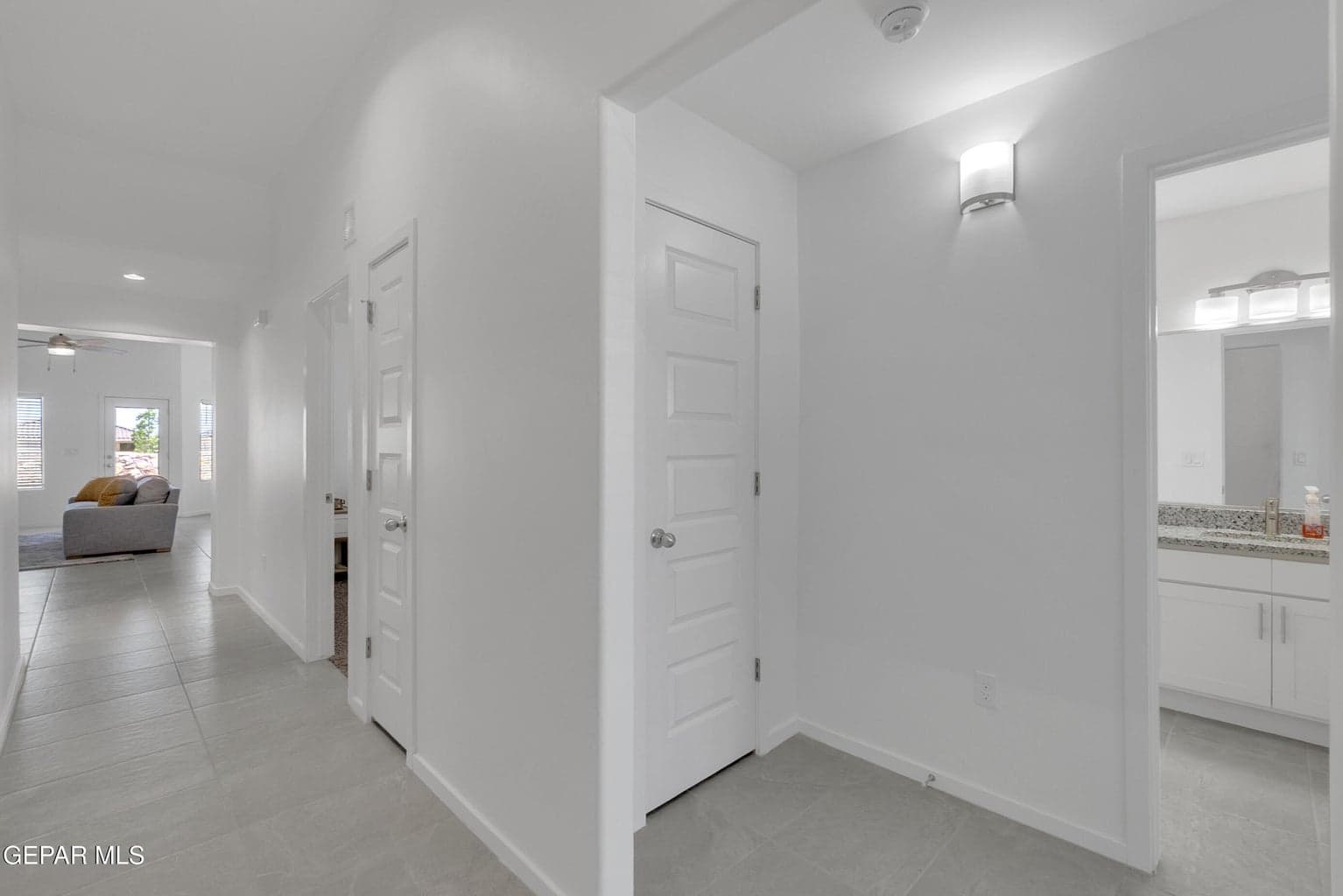 Light gray tile flooring with white walls