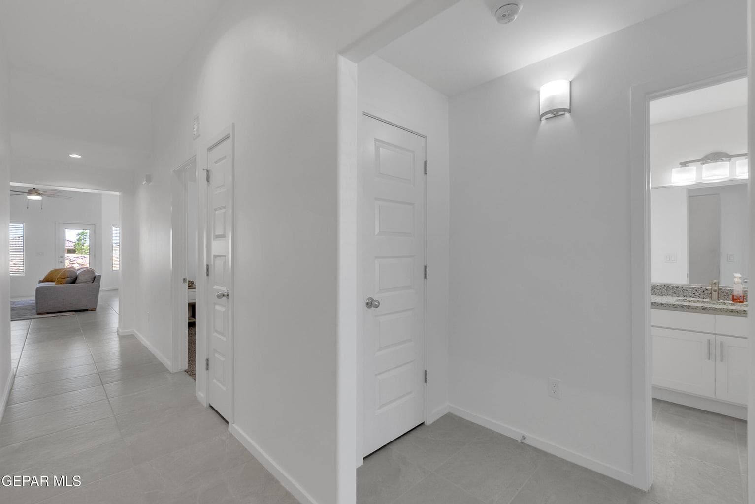 Hallway featuring tile flooring, recessed lighting, and white paneled doors