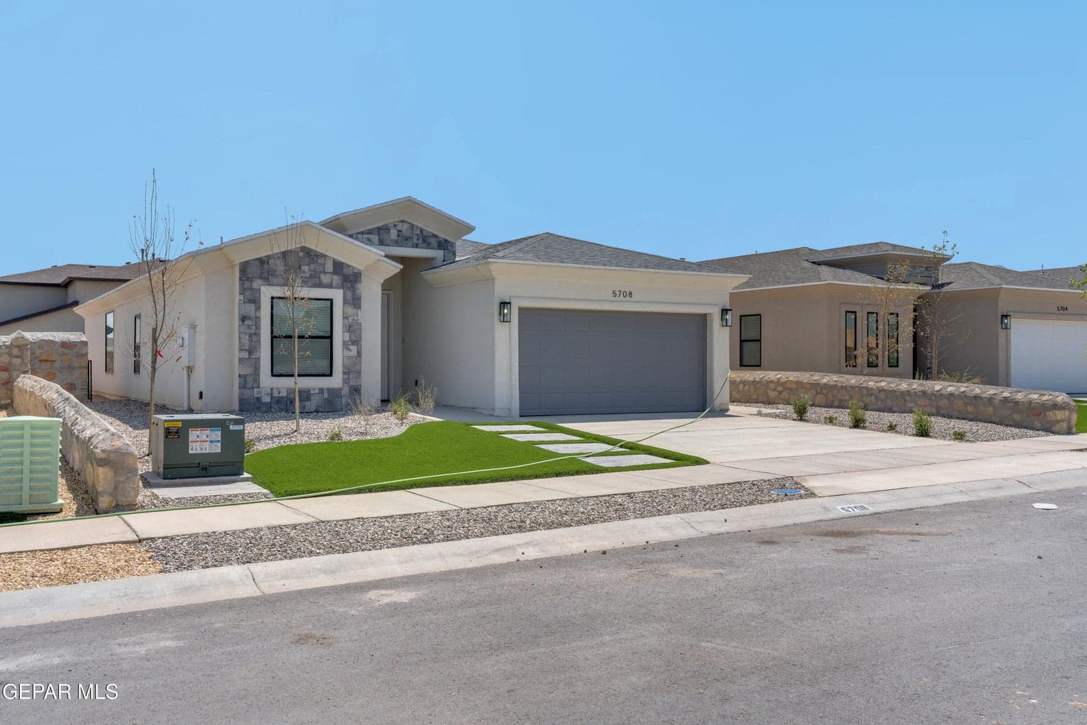 Contemporary stucco exterior with stone accents