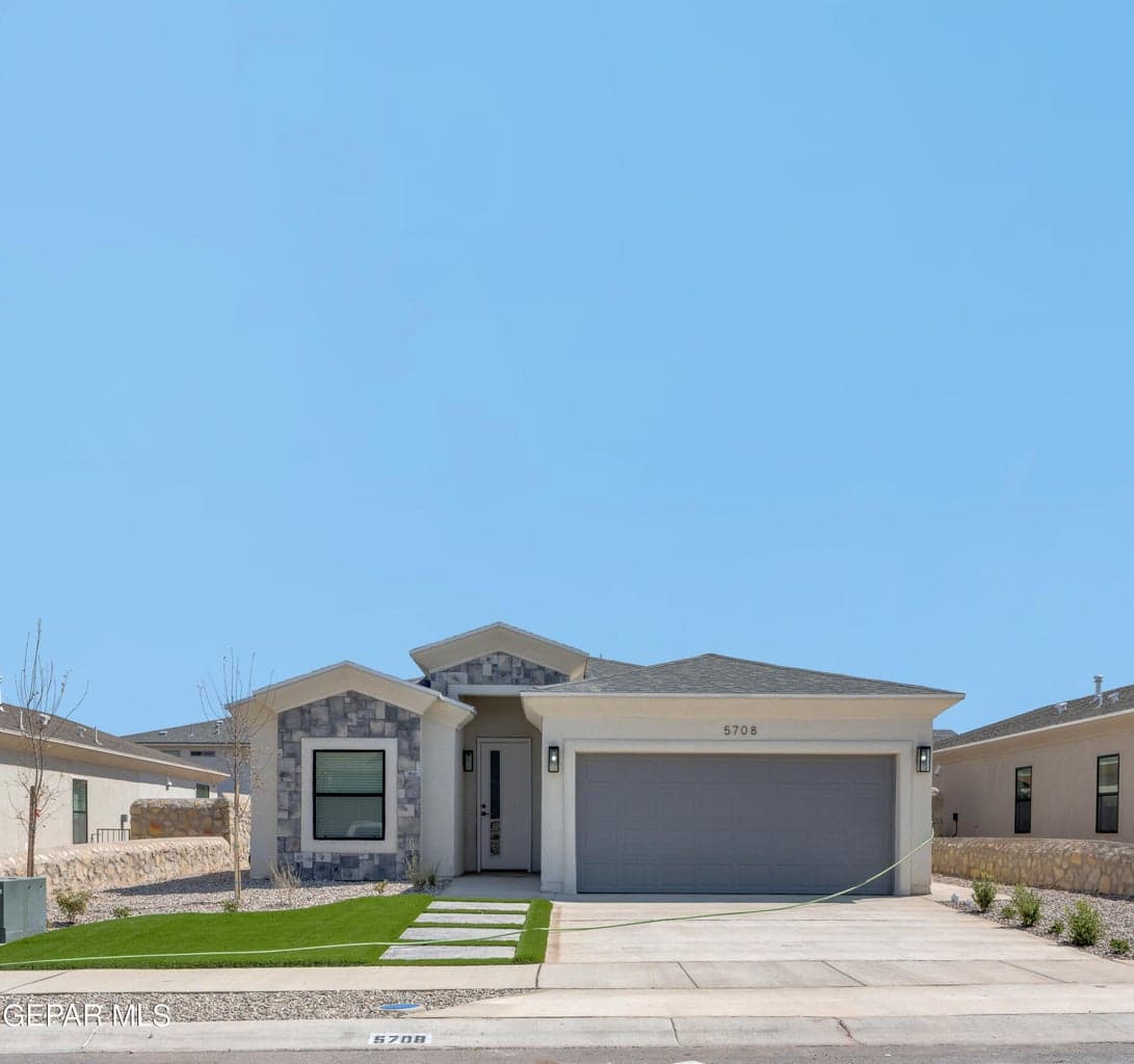 Contemporary exterior with stone façade accents