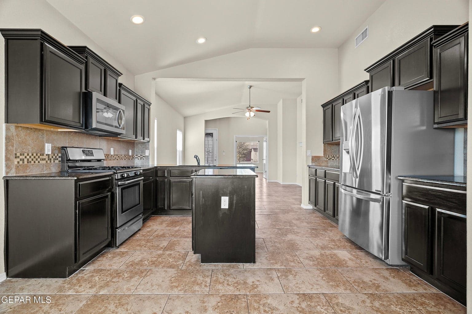 Features granite countertops and ample cabinetry