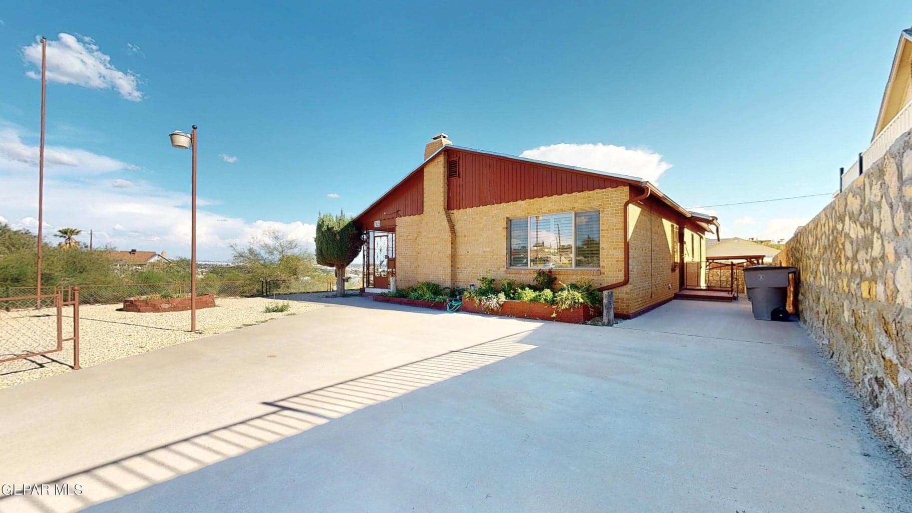Wide driveway fits several cars. Living room and separate kitchen entry.