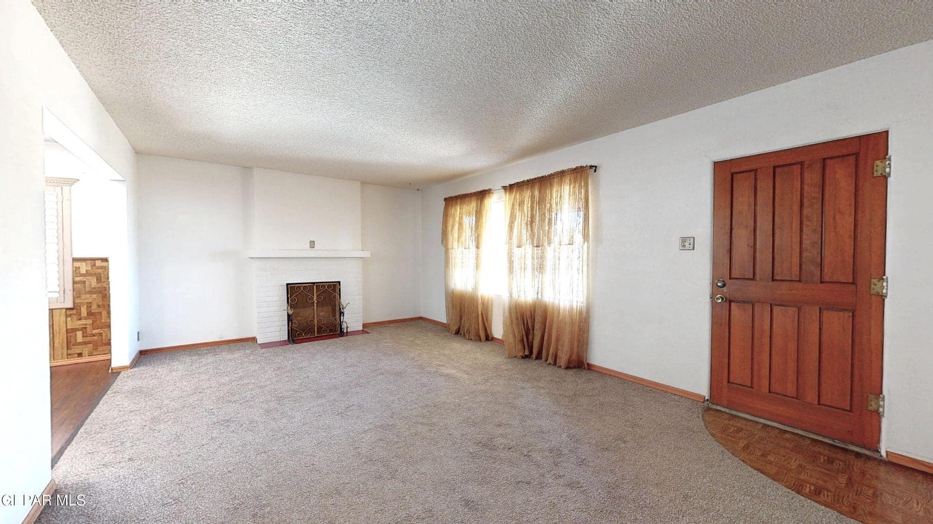 Spacious living room with gas fireplace.