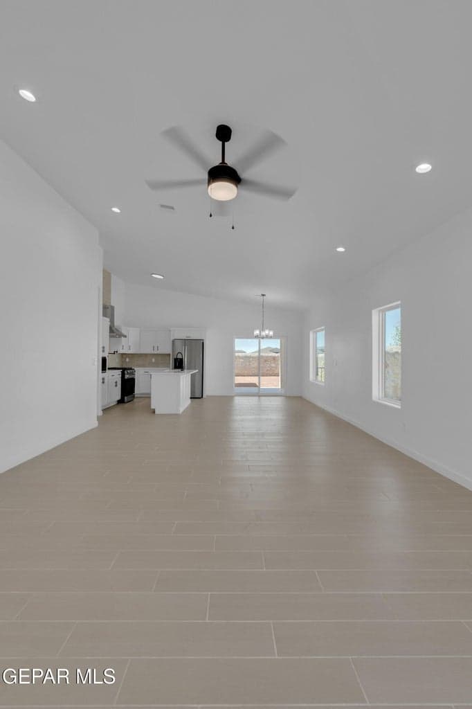 Open-concept living space featuring plank-style tile flooring, recessed lighting, and a modern ceiling fan