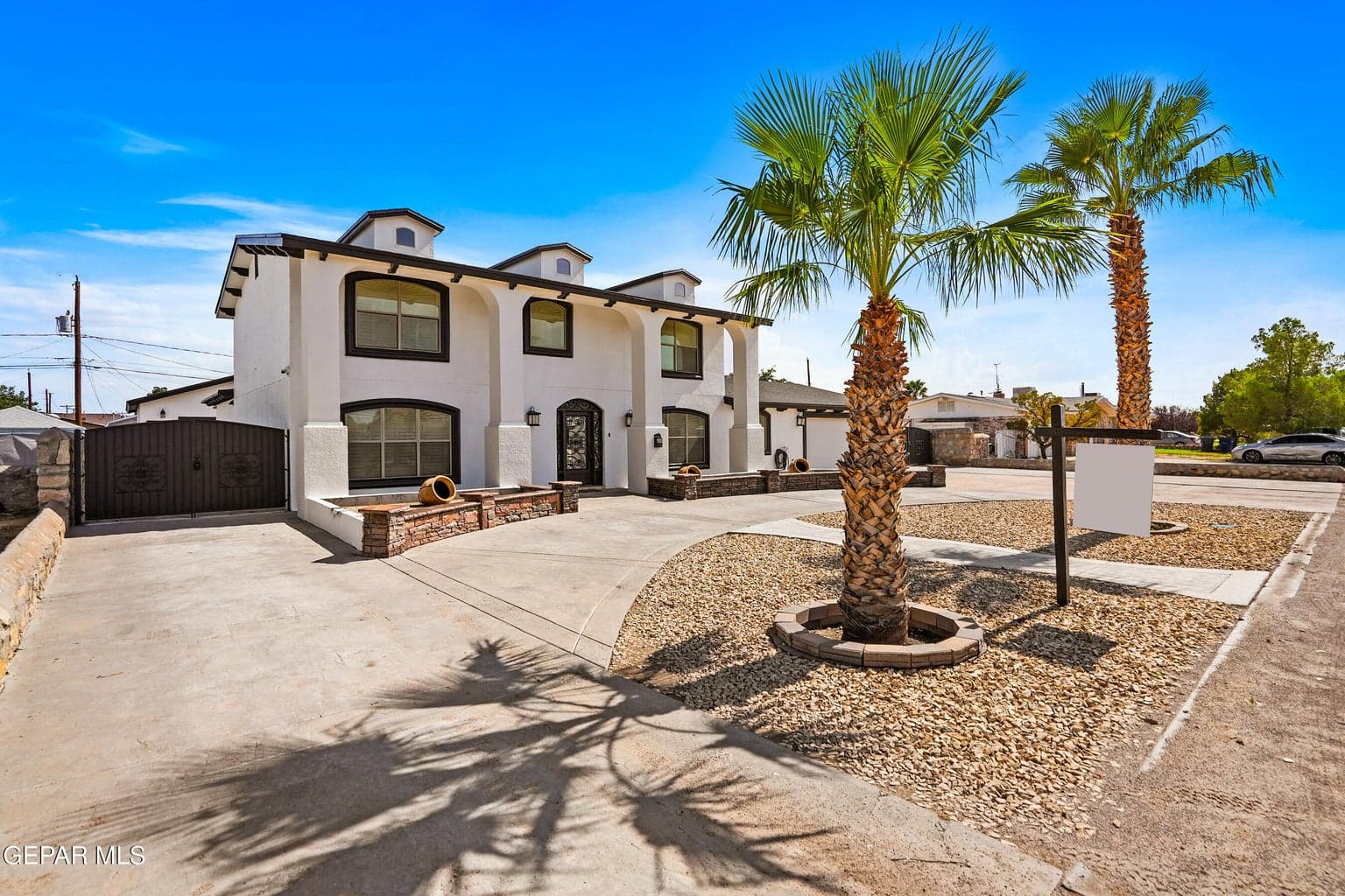 Stucco exterior with contrasting trim, arched windows, and a decorative front entry