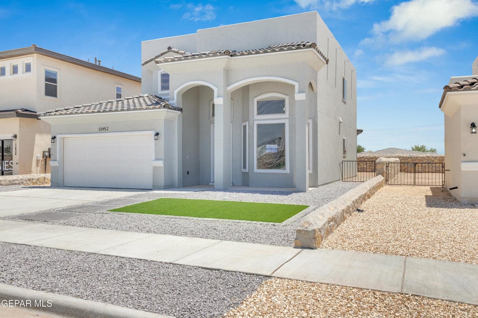 Stucco exterior with a tiled roof and an attached garage