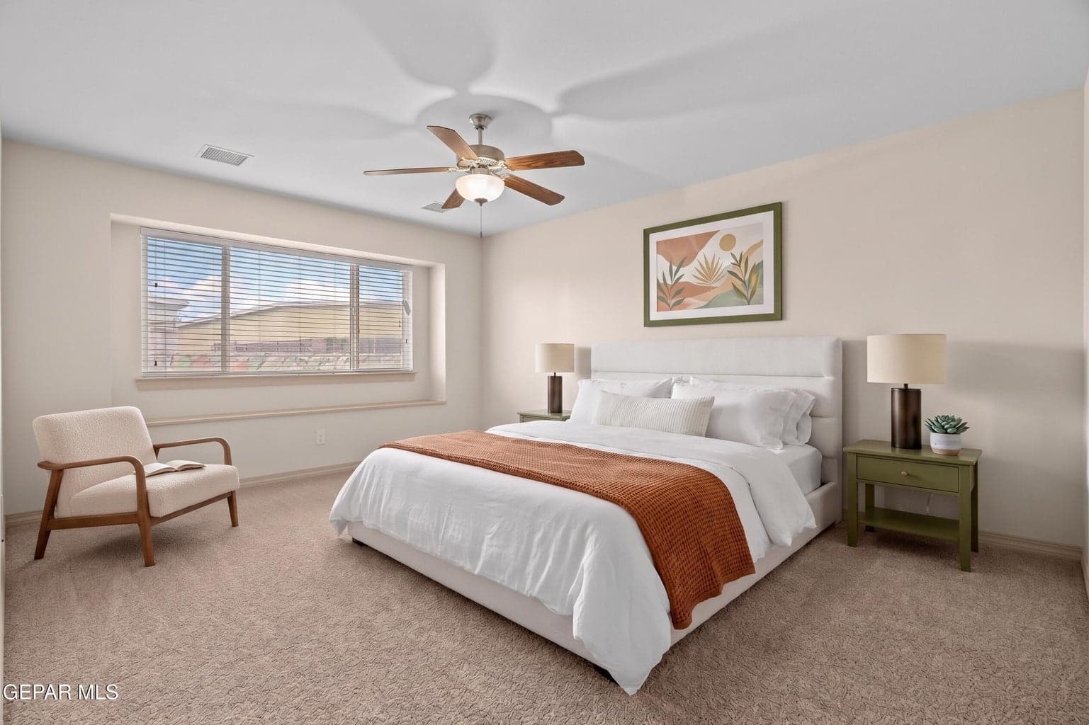 Spacious primary suite with comfortable proportions and carpet flooring creates a cozy feel.