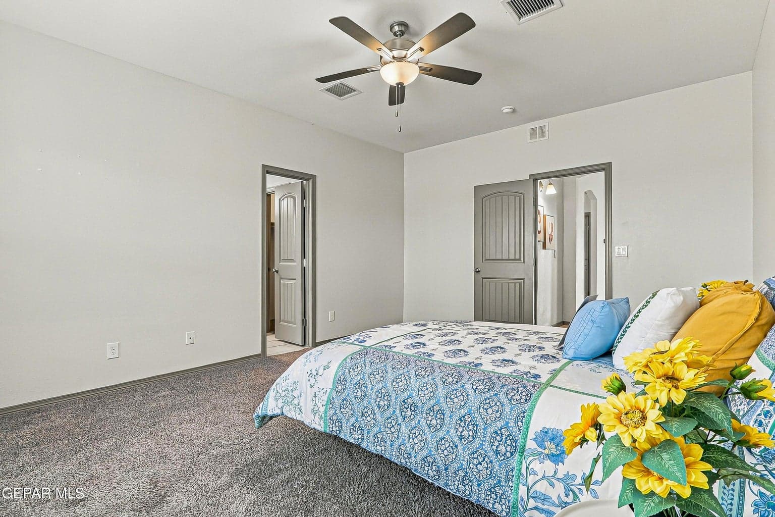 Room featuring a ceiling fan with integrated lighting and carpet flooring